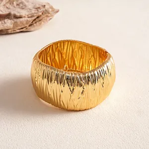 Detail showing the intricate wrinkled texture of this gold geometric cuff bracelet.