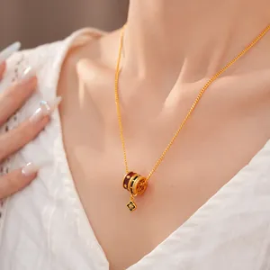 Close-up of 24K gold plated necklace featuring enamel flower pendant with zircon stones.