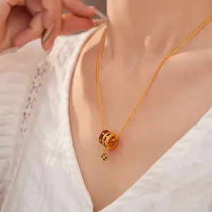 Close-up of 24K gold plated necklace with zircon enamel pendant on model