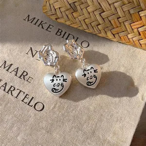 Silver heart dangle earrings featuring a cute cartoon cat design for women's style