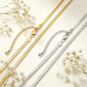 Detailed macro shot of 3mm gold and silver stainless steel flat snake chain necklaces