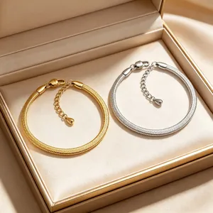 Close-up of 3mm stainless steel blade chain bracelets in gold and silver finish in a gift box.