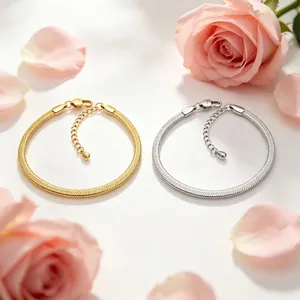 Gold and silver 3mm stainless steel flat blade chain bracelets on a floral background