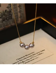 Detailed close-up showing three elegant lavender pearls on a refined 18k gold plated chain.