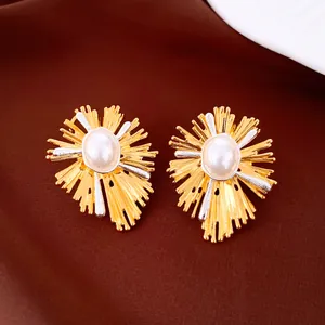 Detail von Vintage-Ohrringen mit ovaler Perle und strukturierter Goldoberfläche.