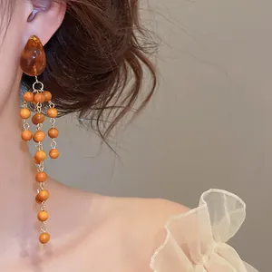 Elegant vintage Maillard style dangling earrings with brown wood beads and amber crystal detail
