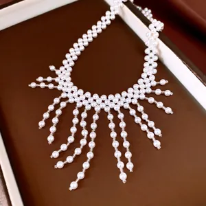 Detailed macro view of a vintage palace style white pearl beaded fringe necklace