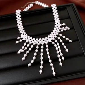 Close-up of elegant vintage style pearl beaded necklace with dangling tassel detail