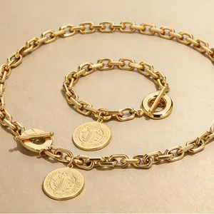 Chunky gold stainless steel jewelry set with embossed coin pendant and OT clasp