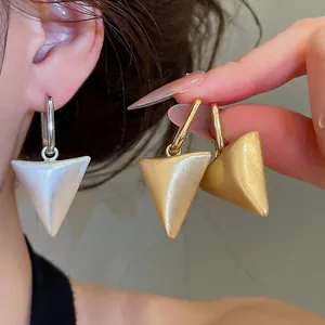 Elegant metallic triangular prism pendant earrings in silver and gold minimalist style