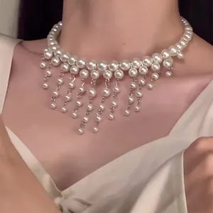 Detailed view of elegant French style white pearl fringe choker necklace worn on neck
