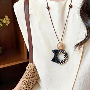 Vintage woven pendant sweater chain necklace with black bow and wooden bead detail