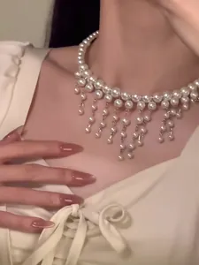 Detailed close-up showing the elegant French style pearl fringe choker necklace worn by a model