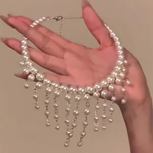 Detail view of a French style pearl beaded choker with elegant dangling tassels