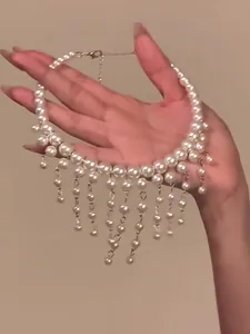 Elegant French style pearl choker necklace with delicate tassel beads held in hand