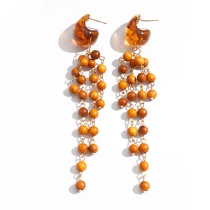 Vintage resin marbled teardrop earrings with long wooden bead tassels on white background