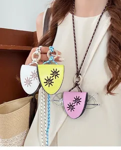 Detail view of leather eyeglass holder necklaces with colorful cords and sun patterns