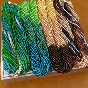 Handcrafted multi-strand seed bead necklaces in vibrant green, teal, gold, and brown
