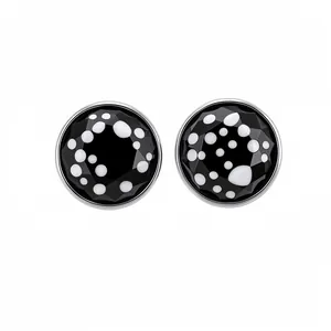 Elegant silver stud earrings featuring black glass with white polka dots for modern style