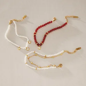 Detailed display of elegant stainless steel bracelets with red agate beads and pearls