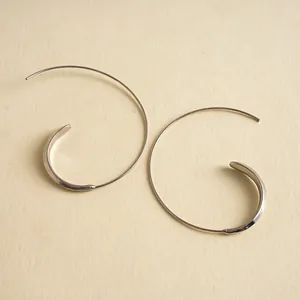 Detailed view of minimalist silver C-shaped geometric metal hoop earrings for women