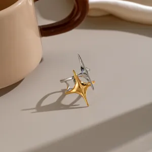 Detailed macro view of a vintage double star open ring with gold and silver finish