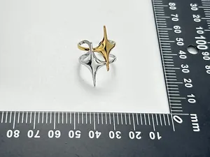 Macro view of the vintage double star open ring shown next to a measuring ruler