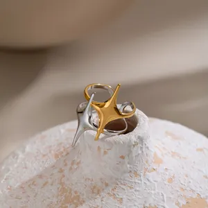 Detailed close-up of French vintage star rings in gold and silver stainless steel