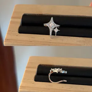 Detail view showing the star-shaped design and secure clip of the zircon ear cuff