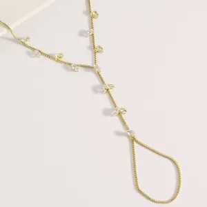 Détail de la gourmette main dorée ornée de pierres en zircon cubique taille marquise