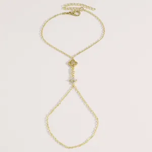 Vue détaillée d'un bracelet bague doré minimaliste avec charme étoile et trèfle en zircon
