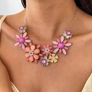 Nahaufnahme einer bunten Halskette mit Acrylblumen und vielen funkelnden Strasssteinen