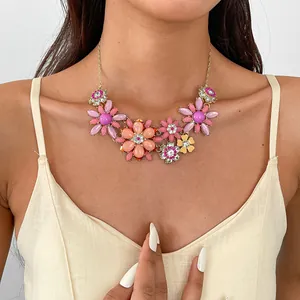 Statement-Halskette mit Acrylblumen und bunten Strasssteinen, von Model getragen
