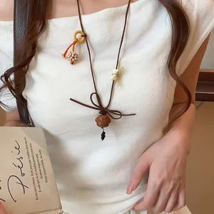 Detailed view of cute wooden puppy pendant on brown Korean velvet cord necklace