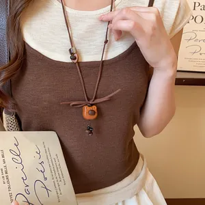 Detailed view of cute wooden puppy pendant necklace with brown Korean velvet cord