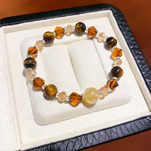 Close-up detail of a vintage Maillard style tiger eye and amber crystal beaded bracelet