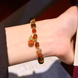Close-up of vintage Maillard style tiger eye and crystal beaded bracelet on wrist