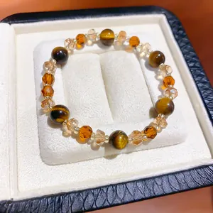 Detailed view of a retro tiger eye and faceted crystal beaded bracelet in a gift box