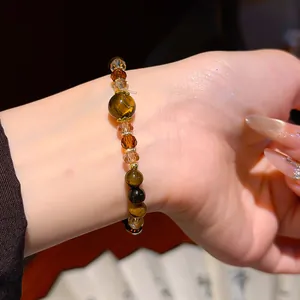 Close-up detail of a vintage Maillard style tiger eye stone and crystal beaded bracelet