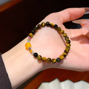 Close-up of vintage tiger's eye beaded bracelet on wrist showcasing natural stone texture