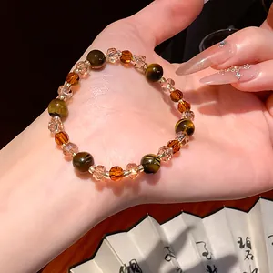 Detailed view of Maillard style tiger eye stone and crystal beaded bracelet on hand