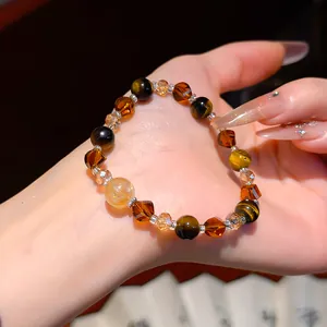 Macro detail of Maillard style vintage tiger's eye and amber crystal beaded bracelet on hand