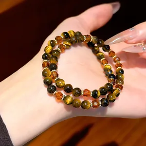 Close-up detail of a vintage style tiger eye stone beaded bracelet with amber crystal accents