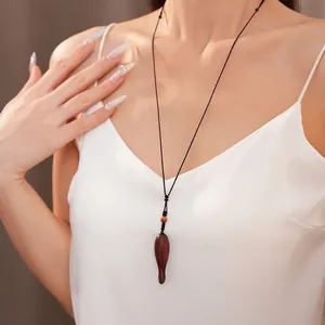 Handcrafted wooden fish pendant necklace with adjustable black braided rope cord