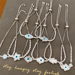 Λεπτομέρεια από ασημένια βραχιόλια με Evil Eye, Hamsa και αστέρια από ζιργκόν και κοχύλι