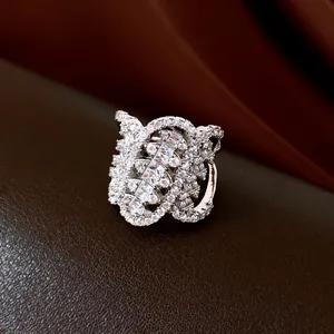 Detailed view of the zircon-studded geometric twisted oval ring in silver finish