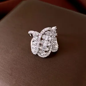 Macro shot of luxury geometric twisted oval open ring with sparkly white zircon stones