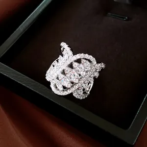 Macro view of a luxury geometric twisted oval ring set with sparkling zircons in a box.