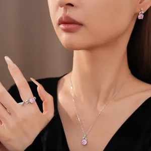 Detailed view of a French minimalist pink zircon flower jewelry set on an Asian model