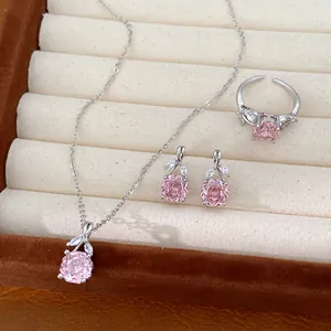 Detail view of French style pink flower zircon jewelry set including necklace, earrings and ring.